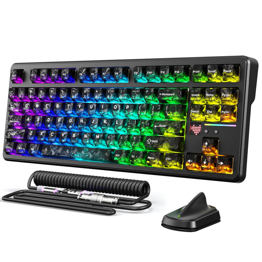 Wireless gaming keyboard with RGB lighting, coiled cable, and wireless receiver arranged on a desk